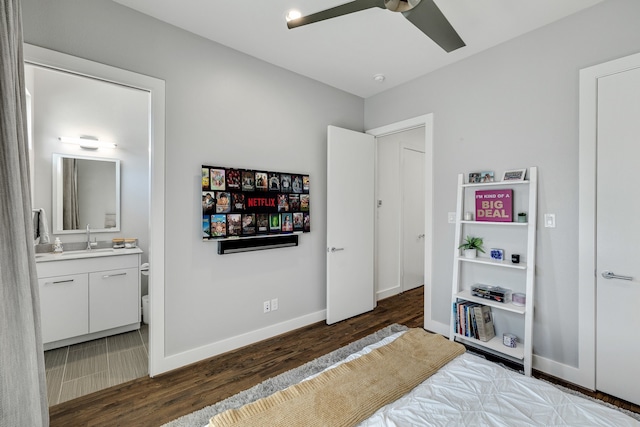 bedroom with ceiling fan, dark hardwood / wood-style flooring, sink, and connected bathroom