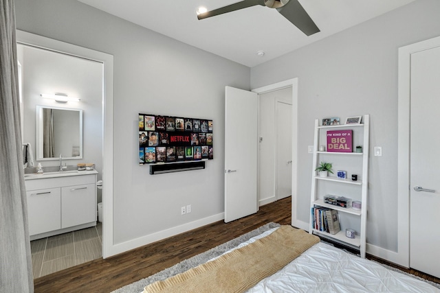 bedroom with sink, dark hardwood / wood-style floors, and ensuite bathroom