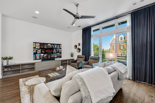 living room with hardwood / wood-style flooring and ceiling fan