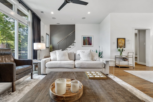 living room with ceiling fan and light hardwood / wood-style floors