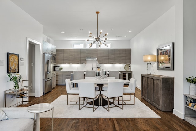 dining space featuring a notable chandelier and dark hardwood / wood-style flooring