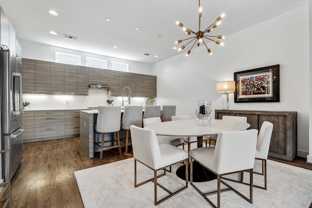 dining area featuring dark hardwood / wood-style floors and an inviting chandelier