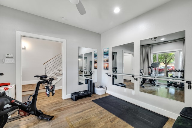 workout room with hardwood / wood-style floors and ceiling fan