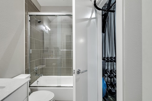 full bathroom featuring vanity, enclosed tub / shower combo, and toilet