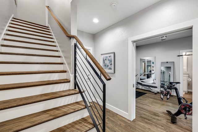 stairway with hardwood / wood-style flooring