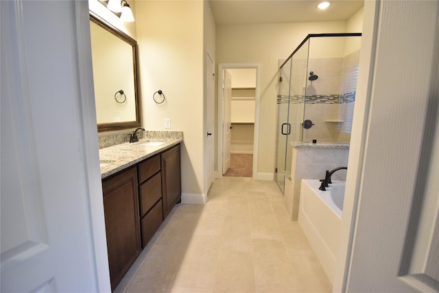 bathroom with tile patterned flooring, vanity, and shower with separate bathtub