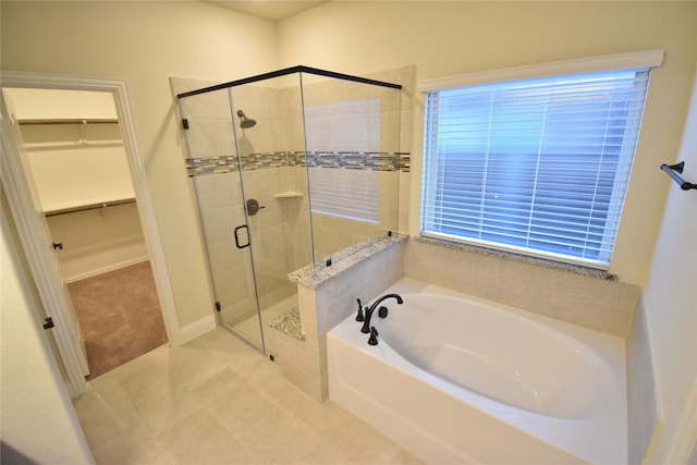 bathroom featuring tile patterned flooring and independent shower and bath