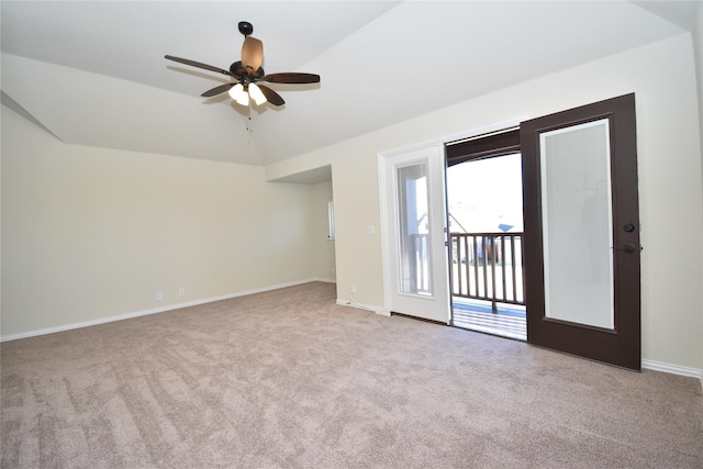 unfurnished room with ceiling fan, light colored carpet, and vaulted ceiling