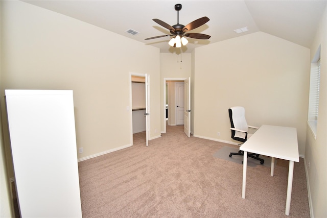 unfurnished office featuring ceiling fan, light carpet, and vaulted ceiling