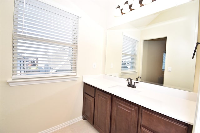 bathroom with a wealth of natural light, tile patterned flooring, and vanity