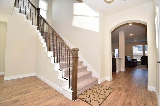 staircase with hardwood / wood-style floors