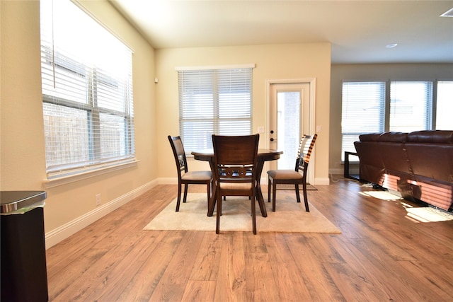 dining room with plenty of natural light and light hardwood / wood-style floors