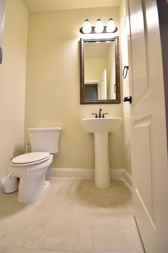 bathroom featuring toilet and tile patterned floors