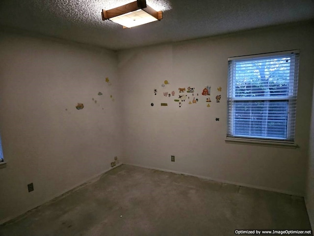 unfurnished room featuring a textured ceiling