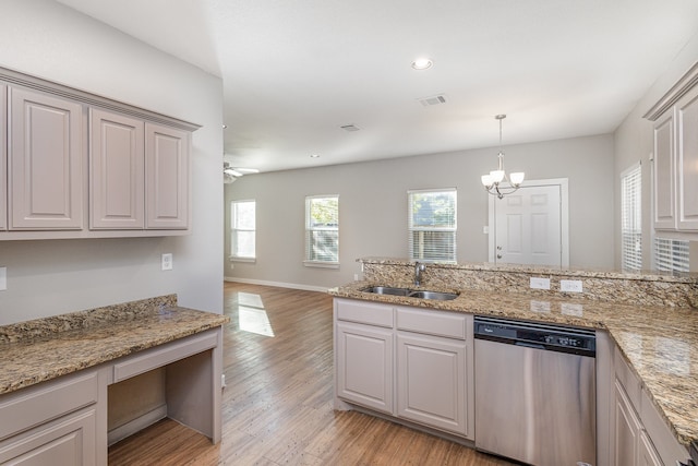 kitchen with stainless steel dishwasher, light hardwood / wood-style floors, sink, and a wealth of natural light