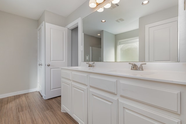 bathroom with hardwood / wood-style flooring and vanity