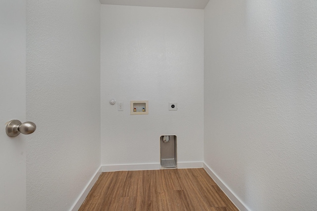 clothes washing area with gas dryer hookup, washer hookup, hardwood / wood-style floors, and electric dryer hookup