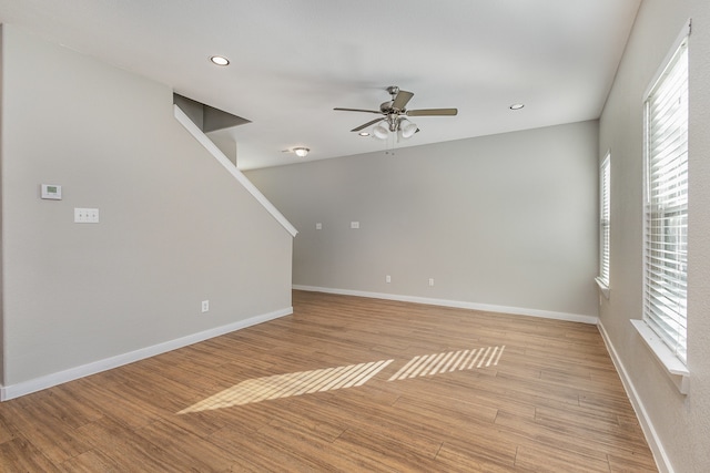 spare room featuring ceiling fan, plenty of natural light, and light hardwood / wood-style floors