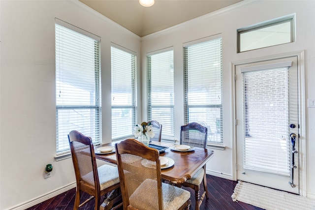 dining area featuring crown molding, dark hardwood / wood-style flooring, and a healthy amount of sunlight