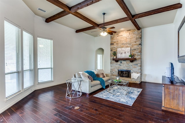 living room featuring a fireplace, a healthy amount of sunlight, dark wood-type flooring, and coffered ceiling