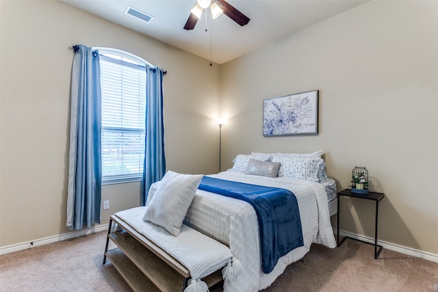 bedroom featuring multiple windows, ceiling fan, and light carpet