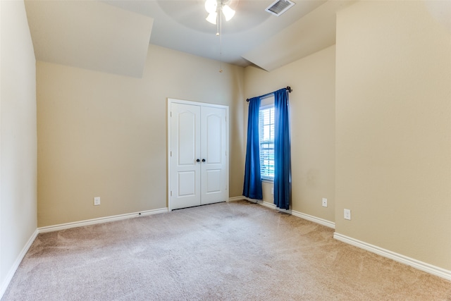 carpeted spare room with ceiling fan