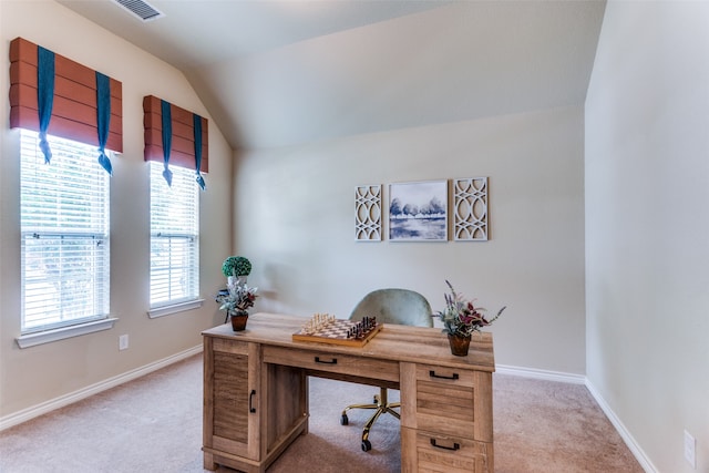 carpeted home office with vaulted ceiling