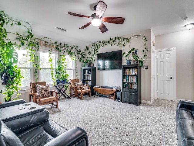 carpeted living room with ceiling fan