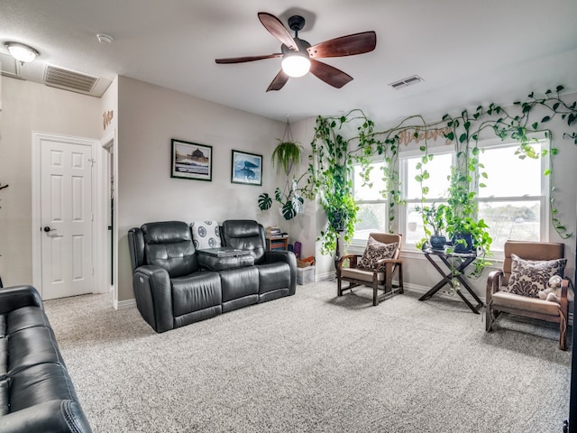 living room featuring ceiling fan and carpet