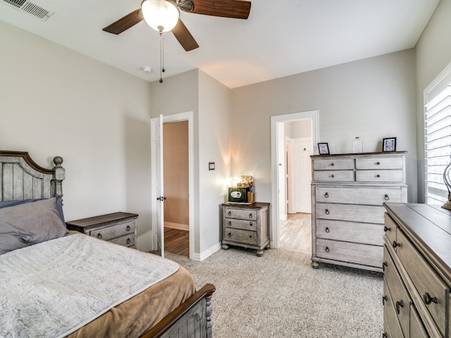 bedroom with ceiling fan and light colored carpet