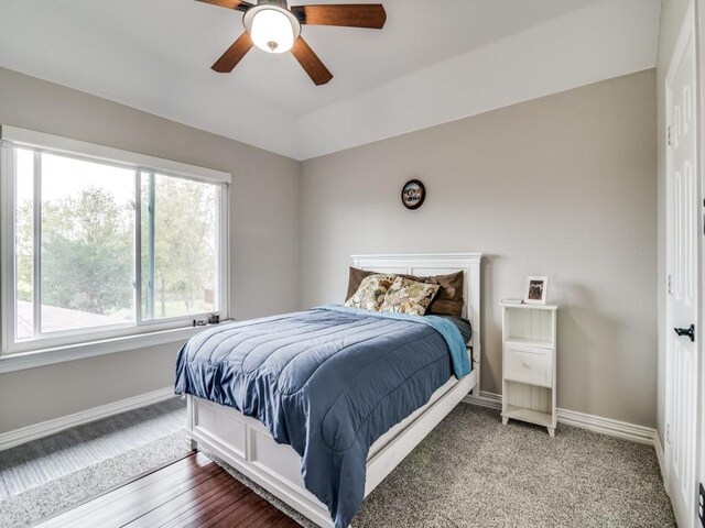 carpeted bedroom featuring ceiling fan and lofted ceiling