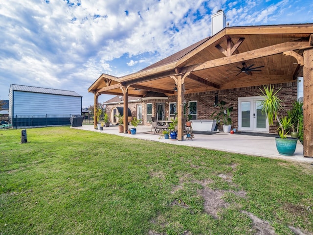 view of yard featuring french doors, ceiling fan, and a patio area