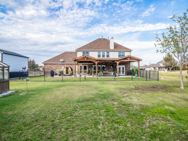 rear view of property with a yard and a patio area