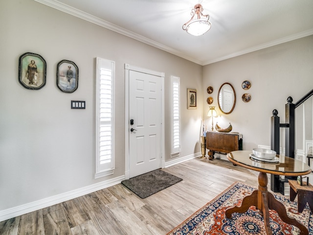 entrance foyer featuring hardwood / wood-style flooring, plenty of natural light, and crown molding