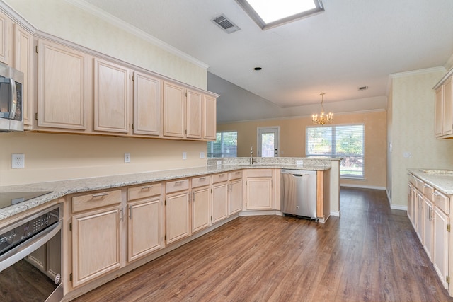 kitchen with kitchen peninsula, dark hardwood / wood-style flooring, stainless steel appliances, crown molding, and a notable chandelier