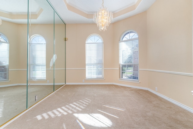 unfurnished bedroom featuring carpet floors, a tray ceiling, and crown molding