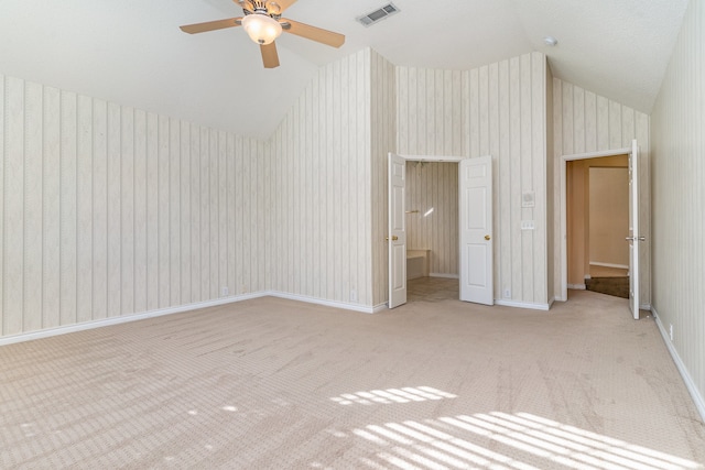 interior space featuring a textured ceiling, light colored carpet, ceiling fan, and lofted ceiling