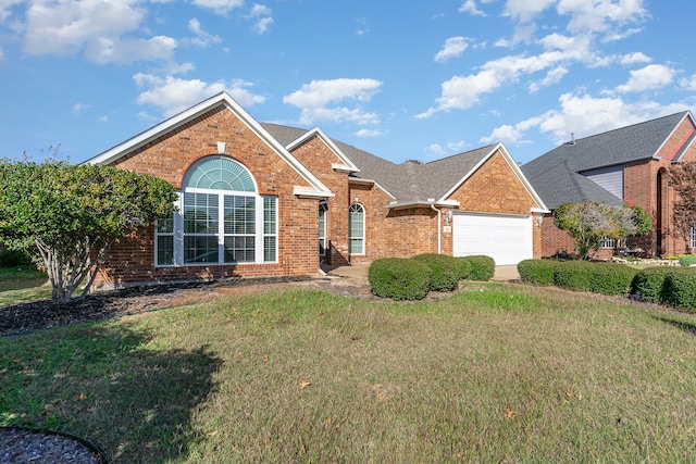 view of property with a garage and a front lawn