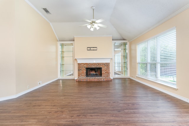 unfurnished living room with dark hardwood / wood-style floors, crown molding, a fireplace, and vaulted ceiling