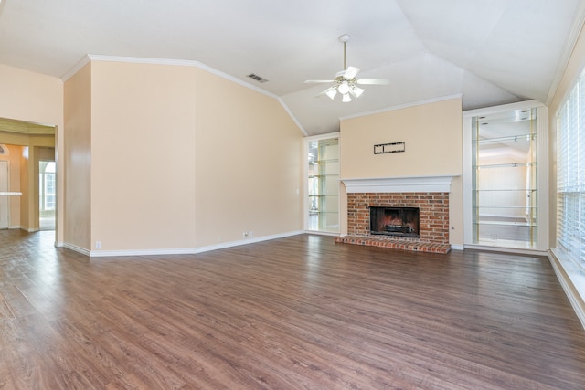 unfurnished living room featuring vaulted ceiling, a brick fireplace, dark hardwood / wood-style floors, ceiling fan, and ornamental molding