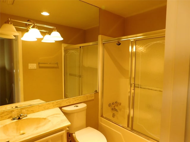 full bathroom with vanity, combined bath / shower with glass door, and toilet