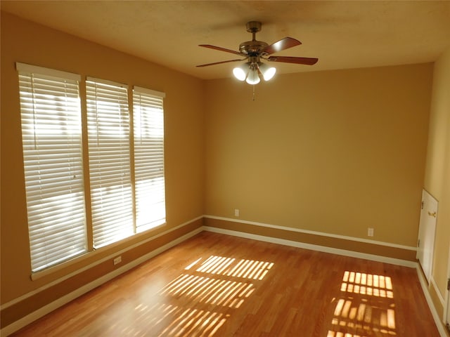 spare room with wood-type flooring and ceiling fan