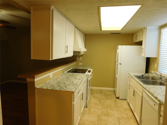 kitchen featuring custom exhaust hood, white appliances, sink, white cabinetry, and light tile patterned flooring