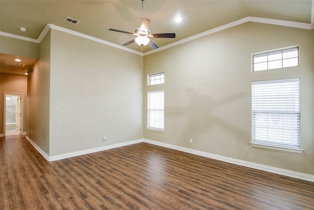 spare room with a healthy amount of sunlight, crown molding, ceiling fan, and dark wood-type flooring