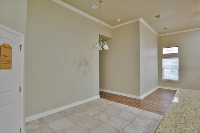 unfurnished room featuring an inviting chandelier, light hardwood / wood-style floors, and ornamental molding