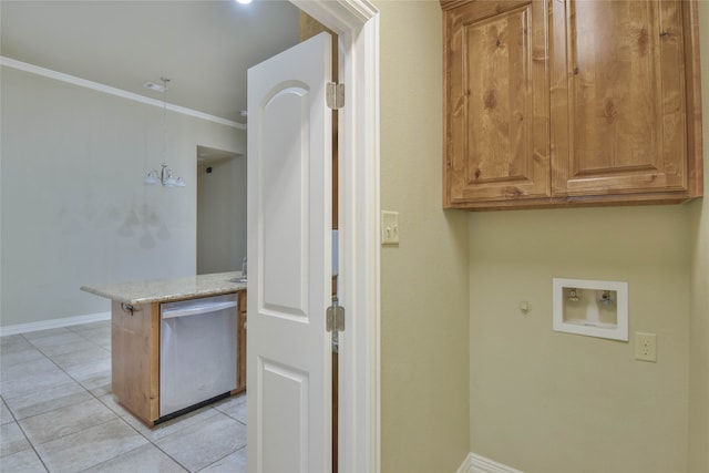 laundry area featuring gas dryer hookup, cabinets, crown molding, washer hookup, and light tile patterned floors