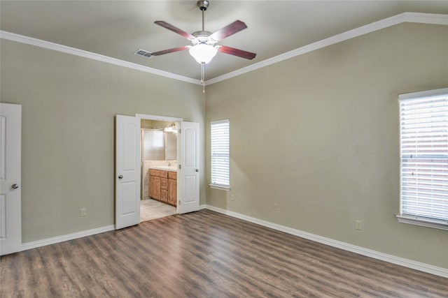 unfurnished bedroom featuring ensuite bath, ceiling fan, crown molding, and wood-type flooring