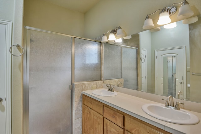 bathroom with a shower with door and vanity