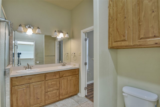 bathroom with tile patterned flooring, vanity, and toilet