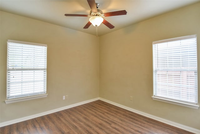 spare room with ceiling fan and dark hardwood / wood-style floors